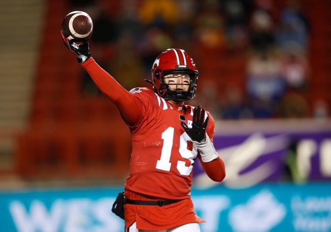 Calgary Stampeders quarterback Bo Levi Mitchell throws a pass against the Winnipeg Blue Bombers during the first half of their CFL football game in Calgary, Saturday, Nov. 20, 2021.The Calgary Stampeders have agreed to a restructured contract with star quarterback Bo Levi Mitchell. THE CANADIAN PRESS/Todd Korol