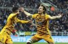 Cambridge United's Joe Ironside, right, celebrates scoring during the English FA Cup third round soccer match between Newcastle United and Cambridge United at St. James' Park, Newcastle upon Tyne, England, Saturday Jan. 8, 2022. (Owen Humphreys/PA via AP)