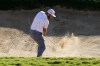 Jon Rahm, of Spain, hits out of the 14th bunker during the third round of the Tournament of Champions golf event, Saturday, Jan. 8, 2022, at Kapalua Plantation Course in Kapalua, Hawaii. (AP Photo/Matt York)