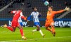 Cologne's Anthony Modeste, left, scores the opening goal during the German Bundesliga soccer match between Hertha BSC Berlin and 1. FC Cologne in Berlin, Germany, Sunday, Jan. 9, 2022. (Andreas Gora/dpa via AP)