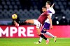 Torino's Bremer, left, and Fiorentina's Dusan Vlahovic battle for the ball during the Serie A soccer match between Torino and Fiorentina at the Olympic stadium in Turin, Italy, Monday, Jan. 10 2022. (Fabio Ferrari/LaPresse via AP)