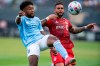 New York FC midfielder Chris Gloster, left, fights for the ball against Toronto FC forward Dom Dwyer during an MLS soccer match at Yankee Stadium on, Saturday, May 15, 2021. in New York. THE CANADIAN PRESS/AP/Eduardo Munoz Alvarez