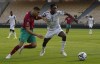 Morocco's Achraf Hakimi, left, is challenged by Ghana's Baba Iddrissu during the African Cup of Nations 2022 group A soccer match between Morocco and Ghana at the Ahmadou Ahidjo stadium in Yaounde, Cameroon, Monday Jan. 10, 2022. (AP Photo/Themba Hadebe)