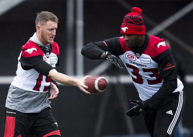 Calgary Stampeders quarterback Bo Levi Mitchell (19) hands the ball off to teammate Jerome Messam (33) during practice ahead of the105th Grey Cup championship football game against the Toronto Argonauts, in Ottawa on Saturday, Nov. 25, 2017. THE CANADIAN PRESS/Nathan Denette