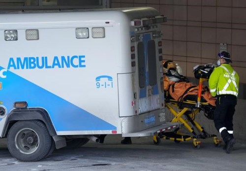 Paramedics transfer a patient out of their ambulance to the emergency department at Michael Garron Hospital during the COVID-19 pandemic in Toronto on Monday, January 10, 2022. THE CANADIAN PRESS/Nathan Denette