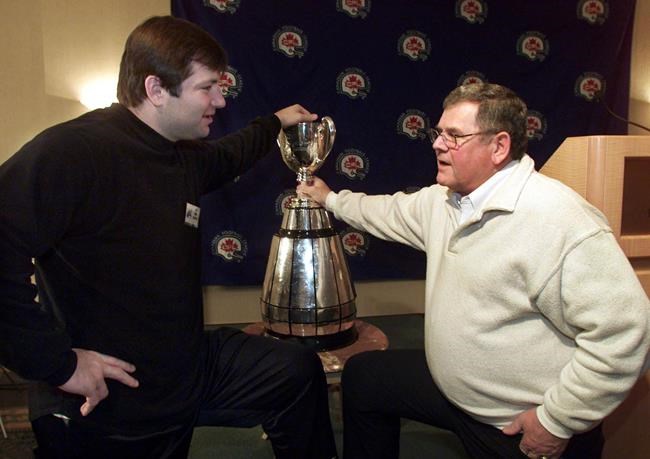 Hamilton Tiger-Cats tackle Mike Philbrick (left) chats with defensive co-ordinator Don Sutherin at the team's media luncheon in Vancouver, Thursday, Nov. 25, 1999. THE CANADIAN PRESS/Ryan Remiorz