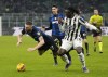 Juventus' Moise Kean, right, challenges for the ball with Inter Milan's Milan Skriniar during the Italian Super Cup final soccer match between Inter Milan and Juventus at the San Siro Stadium, in Milan, Italy, Wednesday, Jan. 12, 2022. (AP Photo/Luca Bruno)