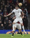 Burnley's Chris Wood, front, challenges for the ball with Manchester United's Harry Maguire during the English Premier League soccer match between Manchester United and Burnley at Old Trafford in Manchester, England, Thursday, Dec. 30, 2021. (AP Photo/Rui Vieira)