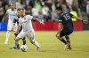 FILE - Real Salt Lake midfielder Albert Rusnák (11) looks for an opening around Sporting Kansas City midfielder Roger Espinoza (15) during the second half of an MLS soccer match, on Nov. 7, 2021, in Kansas City, Kan. The Seattle Sounders added a key piece to their midfield for the upcoming season on Thursday, Jan. 13, 2022, by signing Rusnák to a designated player contract. (AP Photo/Nick Tre. Smith, File)