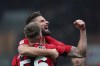 AC Milan's Alexis Saelemaekers, front, celebrates after scoring his team's third goal with AC Milan's Olivier Giroud, during an Italian Cup soccer match between AC Milan and Genoa at the San Siro stadium in Milan, Italy, Thursday, Jan. 13, 2022. (Spada/LaPresse via AP)
