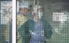 Health-care workers are pictured through the front window at the Lions Gate Hospital in North Vancouver, B.C., Monday, April 13, 2020.&nbsp;While the most challenging days are predicted to come for British Columbia’s health care system as COVID-19 cases peak in the latest wave, representatives for doctors and nurses say their members are already reaching a breaking point.&nbsp;THE CANADIAN PRESS/Jonathan Hayward