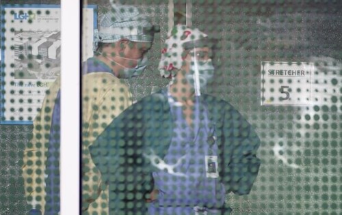 Health-care workers are pictured through the front window at the Lions Gate Hospital in North Vancouver, B.C., Monday, April 13, 2020.&nbsp;While the most challenging days are predicted to come for British Columbia’s health care system as COVID-19 cases peak in the latest wave, representatives for doctors and nurses say their members are already reaching a breaking point.&nbsp;THE CANADIAN PRESS/Jonathan Hayward