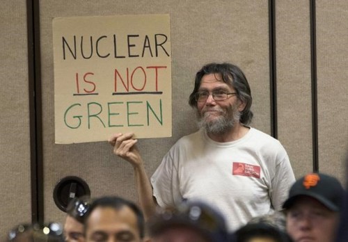 FILE - Peter Galbraith displays his opposition to a proposal to waive an environmental review of the Diablo Canyon Nuclear Power plant before renewing the plant's license, Tuesday, June 28, 2016, in Sacramento, Calif. As climate change pushes states in the U.S. to dramatically cut their use of fossil fuels, many are coming to the conclusion that solar, wind and other renewable power sources won't be enough to keep the lights on. Nuclear power is emerging as an answer to fill the gap as states transition away from coal, oil and natural gas to reduce greenhouse gas emissions and stave off the worst effects of a warming planet.  (AP Photo/Rich Pedroncelli, File)