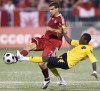 Jamaica's Demar Phillips (right) and Canada's Paul Stalteri vie for the ball during first half FIFA World Cup qualifying action in Toronto on August 20, 2008. Toronto FC head coach Bob Bradley has added former Canadian international Paul Stalteri to his coaching staff. THE CANADIAN PRESS/Frank Gunn