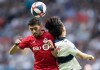 Toronto FC's Mark Delgado, left, and Vancouver Whitecaps' Inbeom Hwang collide as they vie for the ball during the second half of an MLS soccer game in Vancouver on Friday May 31, 2019. THE CANADIAN PRESS/Darryl Dyck
