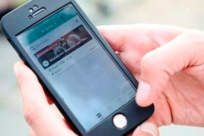 Annekathrin Fiesinger shows how to use the food sharing app 'Too Good To Go' during an interview with the Associated Press in Berlin, Tuesday, May 21, 2019. Too Good To Go is one of many food rescue apps operating in Canada and is helping to reduce grocery and dining bills, while ensuring food that’s due to go off soon but still fit for consumption doesn’t go to waste. (AP Photo/Markus Schreiber)