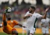 Algeria's Said Benrahma, right, watches on as Ivory Coast's Serge Aurier kicks the ball during the African Cup of Nations 2022 group E soccer match between Ivory Coast and Algeria at the Japoma Stadium in Douala, Cameroon, Thursday, Jan. 20, 2022. (AP Photo/Themba Hadebe)