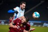 Bayern's Niklas Suele, below, and Berlin's Lucas Tousart battle for the ball during the German Bundesliga soccer match between Hertha Berlin and Bayern Munich at the Olympiastadion in Berlin, Sunday, Jan. 23, 2022. (Soeren Stache/dpa via AP)