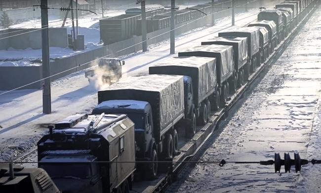In this photo taken from video provided by the Russian Defense Ministry Press Service, Russian military vehicles on a railway platform on their way to attend a joint military drills in Belarus, in Russia, Monday, Jan. 24, 2022. Russia has sent an unspecified number of troops from the country's far east to its ally Belarus, which shares a border with Ukraine, for major war games next month. (Russian Defense Ministry Press Service via AP)