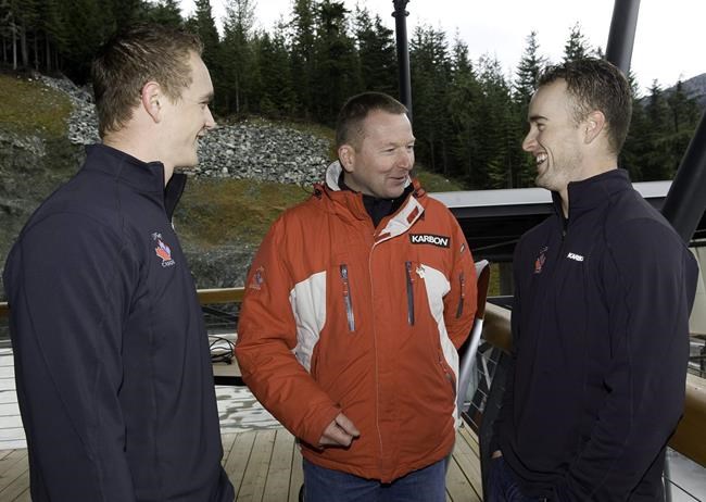 FILE PHOTO: Wolfgang Staudinger (centre), head coach of the Canadian luge team, talks to brothers and teammates in double luge Chris, left, and Mike Moffat, right, prior to training at the Whistler Sliding Center in Whistler, B.C., Monday, Nov.10, 2008. THE CANADIAN PRESS/Bonny Makarewicz