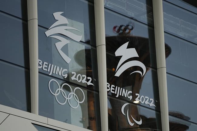 The Beijing Olympic Tower is reflected on the facade of the main media center at the 2022 Winter Olympics, Tuesday, Jan. 25, 2022, in Beijing. THE CANADIAN PRESS/AP-Jae C. Hong