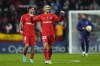 Atletico Madrid's Rodrigo De Paul, left and Mario Hermoso celebrate at the end of a Spanish La Liga soccer match between Atletico Madrid and Valencia at the Wanda Metropolitano stadium in Madrid, Spain, Saturday, Jan. 22, 2022. (AP Photo/Manu Fernandez)