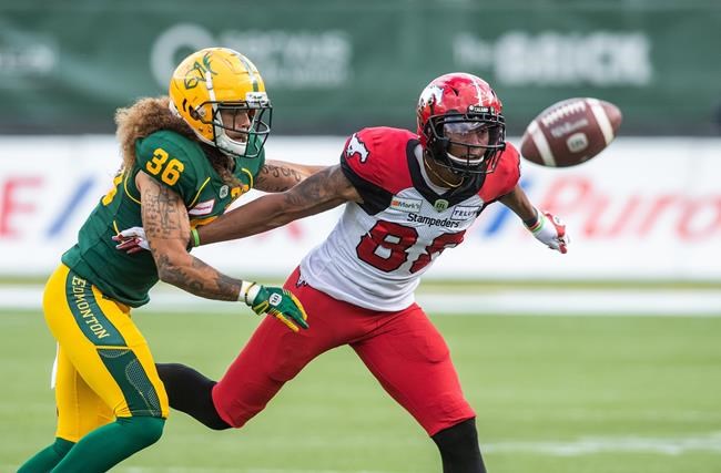 Calgary Stampeders' Kamar Jorden (88) looks for the pass under pressure from Edmonton Elks' Aaron Grymes (36) during first half CFL action in Edmonton, Alta., on Saturday September 11, 2021. THE CANADIAN PRESS/Amber Bracken