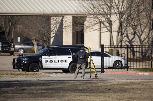 FILE - Law enforcement process the scene in front of the Congregation Beth Israel synagogue, Jan. 16, 2022, in Colleyville, Texas. A Texas man has been charged with a federal gun crime after authorities say he sold a gun to a man who held four hostages inside the synagogue before being fatally shot by the FBI, the Justice Department said Wednesday, Jan. 26, 2022. (AP Photo/Brandon Wade File)