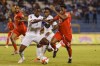 Honduras' Maynor Figueroa, left, and Canada's Jonathan David fight for the ball during a qualifying soccer match for the FIFA World Cup Qatar 2022 in San Pedro Sula, Honduras, Thursday, Jan. 27, 2022. (AP Photo/Delmer Martinez)