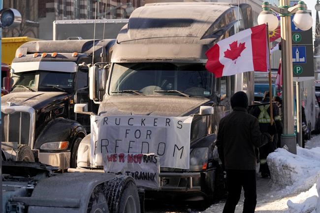 Protesters participating in a cross-country truck convoy protesting measures taken by authorities to curb the spread of COVID-19 and vaccine mandates protest near Parliament Hill in Ottawa on Saturday, Jan. 29, 2022. THE CANADIAN PRESS/Adrian Wyld