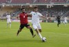 Morocco's Adam Masina, right, vies for the ball with Egypt's Mohamed Salah, during the African Cup of Nations 2022 quarter-final soccer match between Egypt and Morocco at the Ahmadou Ahidjo stadium in Yaounde, Cameroon, Sunday, Jan. 30, 2022. (AP Photo/Themba Hadebe)