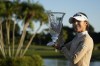 Lydia Ko of New Zealand smiles as she poses with the trophy after winning the Gainbridge LPGA golf tournament, Sunday, Jan. 30, 2022, in Boca Raton, Fla. (AP Photo/Rebecca Blackwell)