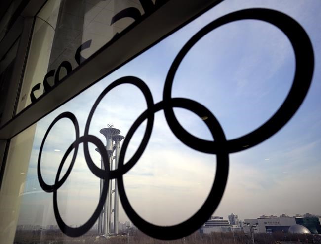 FILE - The Olympic rings are displayed at the main media center for the Beijing Winter Olympics on Tuesday, Jan. 18, 2022, in Beijing. (AP Photo/David J. Phillip, File)