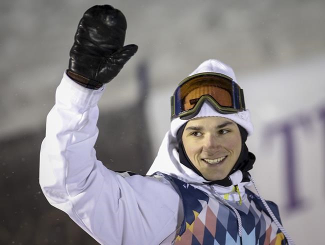 Canada's Derek Livingston celebrates his third place finish in the men's World Cup freestyle halfpipe snowboard event in Calgary, Alta., Friday, Feb. 15, 2019. Livingston will not compete in men's snowboard halfpipe at the Beijing Olympics after sustaining a lower-body injury during a recent training run.THE CANADIAN PRESS/Jeff McIntosh