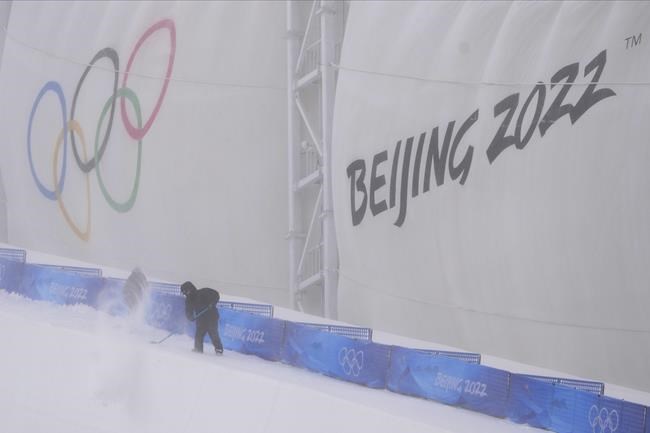 A worker shovels as he prepares for freestyle ski and snowboard events at Genting Snow Park prior to the 2022 Winter Olympics, Monday, Jan. 31, 2022, in Zhangjiakou, China. An international study led by a University of Waterloo researcher published findings last month, suggesting that if global emissions of greenhouse gases are not dramatically reduced, only one of the 21 previous Winter Games sites would be able to safely and viably host another Olympics by the end of this century. THE CANADIAN PRESS/AP-Lee Jin-man