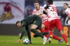 Wolfsburg's Wout Weghorst, left, tries to escape from Leipzig's Willi Orban, 3rd from right, and Hugo Novoa, 2nd from right, during the Bundesliga soccer match between RB Leipzig and VfL Wolfsburg in Leipzig, Germany, Sunday, Jan. 23, 2022. (Jan Woitas/dpa via AP)