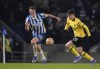 Chelsea's Kai Havertz, right, duels for the ball with Brighton's Dan Burn during the English Premier League soccer match between Brighton and Chelsea at the Falmer stadium in Brighton, England, Tuesday, Jan. 18, 2022. (AP Photo/Matt Dunham)