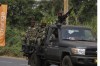 Soldiers patrol outside the entrance of Bafoussam stadium ahead of the African Cup of Nations 2022 group B soccer match between Senegal and Guinea at the Bafoussam Omnisport Stadium, Bafoussam, Cameroon, Friday, Jan. 14, 2022. (AP Photo/Sunday Alamba)