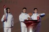Workers prepare the flame for the start of the torch relay for the 2022 Winter Olympics at the Olympic Forest Park in Beijing on Wednesday, Feb. 2, 2022. (AP Photo/Sam McNeil)
