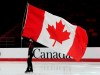 Keegan Messing skates with a Canadian flag after a medal ceremony at the National Skating Championships, Saturday, Jan. 8, 2022 in Ottawa. THE CANADIAN PRESS/Adrian Wyld