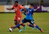 Canada's David Junior Hoilett, left, fights for the ball with El Salvador's Narciso Orellana during a qualifying soccer match for the FIFA World Cup Qatar 2022 at Cuscatlan stadium in San Salvador, El Salvador, Wednesday, Feb. 2, 2022. (AP Photo/Moises Castillo)