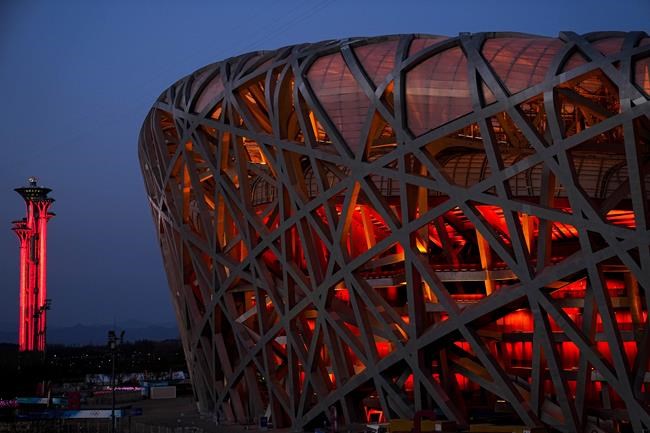 FILE - The National Stadium and the Beijing Olympic Tower are lit in red on the eve of the Chinese New Year ahead of the 2022 Winter Olympics, Jan. 31, 2022, in Beijing. (AP Photo/Jae C. Hong, File)