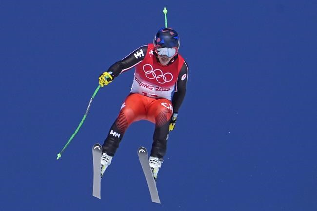 James Crawford, of Canada makes a jump during a men's downhill training run at the 2022 Winter Olympics, Thursday, Feb. 3, 2022, in the Yanqing district of Beijing. (AP Photo/Robert F. Bukaty)