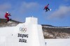 Canadian snowboarder Mark McMorris of Regina, Sask., right is filmed by a member of Team Canada as hits a jump while training on the slopestyle course at the Genting Snow Park prior to the start of the Beijing Winter Olympics in Zhangjiakou, China, Thursday, Feb. 3, 2022. THE CANADIAN PRESS/Sean Kilpatrick