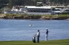 Tom Hoge, right, waits to hit his approach shot from the sixth fairway of the Pebble Beach Golf Links during the first round of the AT&T Pebble Beach Pro-Am golf tournament in Pebble Beach, Calif., Thursday, Feb. 3, 2022. (AP Photo/Eric Risberg)