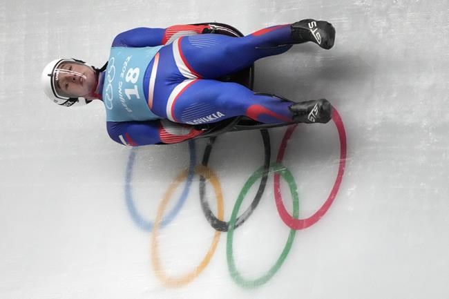Marian Skupek of Slovakia speeds past the Olympic rings during a men's luge training run at the 2022 Winter Olympics, Wednesday, Feb. 2, 2022, in the Yanqing district of Beijing. (AP Photo/Mark Schiefelbein)