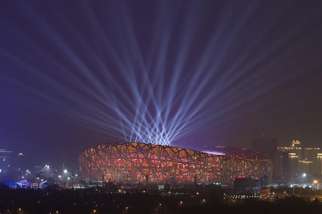 FILE - Lights shine during a rehearsal for the opening ceremony of the 2022 Winter Olympics at the National Stadium, known as the Bird's Nest in Beijing, China, Jan. 30, 2022. The artist Ai Weiwei helped design the stadium for the 2008 Olympics. It's again the venue for the opening ceremony of the 2022 Beijing Winter Olympics. (AP Photo/Wang Xinchao, File)