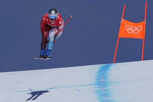 Marco Odermatt of Switzerland makes a jump during men's downhill training at the 2022 Winter Olympics, Friday, Feb. 4, 2022, in the Yanqing district of Beijing. (AP Photo/Robert F. Bukaty)