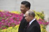 FILE - Russia's President Vladimir Putin, right, reviews a military honor guard with Chinese President Xi Jinping during a welcoming ceremony outside the Great Hall of the People in Beijing, June 8, 2018. Russian President Putin on Friday, Feb. 4, 2022, arrived in Beijing for the opening of the Winter Olympic Games and talks with his Chinese counterpart Xi Jinping, as the two leaders look to project themselves as a counterweight to the U.S. and its allies. (Greg Baker/Pool Photo via AP, File)
