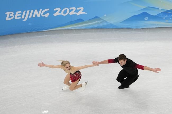 Alexa Knierim and Brandon Frazier, of the United States, compete during the pairs short program figure skating competition at the 2022 Winter Olympics, Friday, Feb. 4, 2022, in Beijing. (AP Photo/Jeff Roberson)